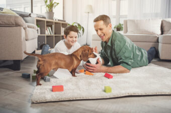 dad and son with puppy