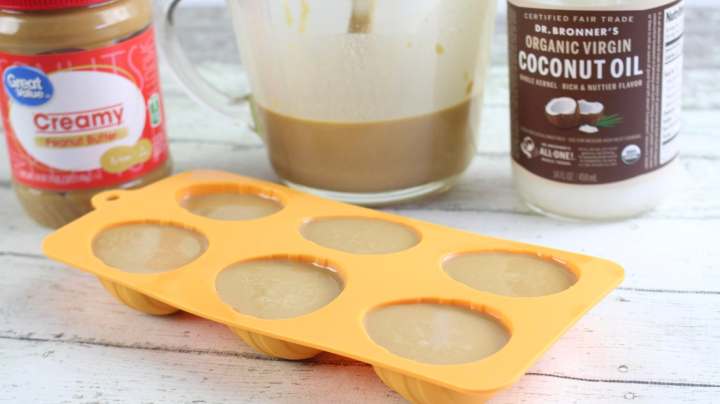 Filled egg shaped silicone molds with peanut butter and coconut 